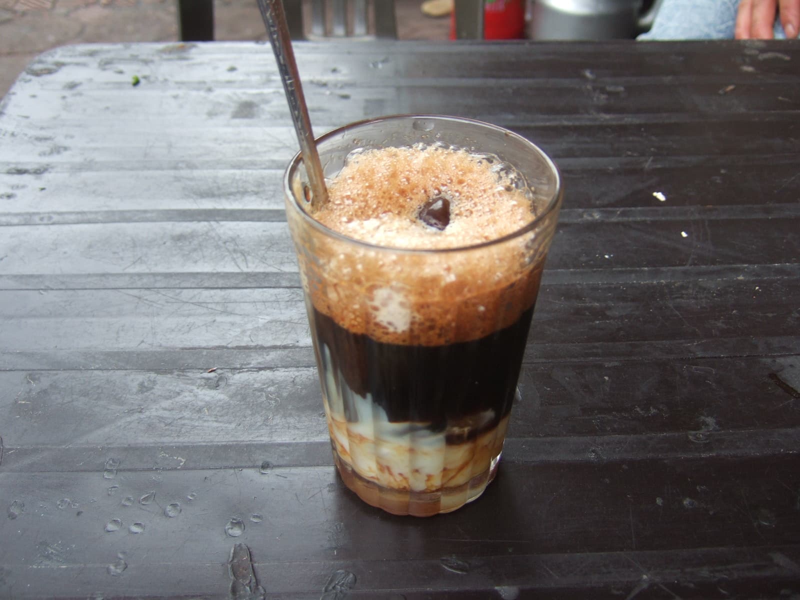 A glass of Vietnamese iced milk coffee, ca phe sua da, the standard order in a Da Nang cafe