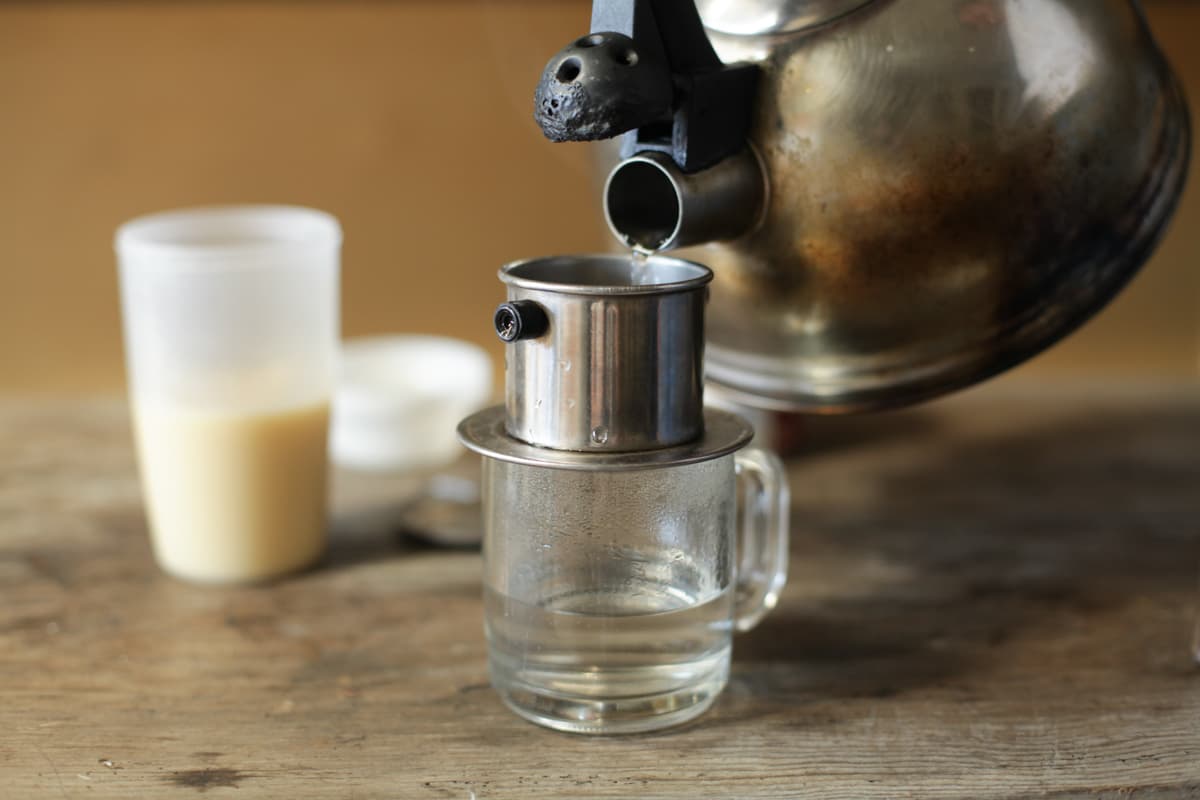 Hot water poured into a phin filter, the traditional Vietnamese coffee brewing method